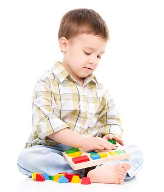 Little boy is playing with toys