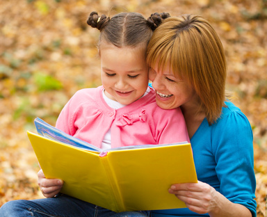 Mother is reading book with her daughter