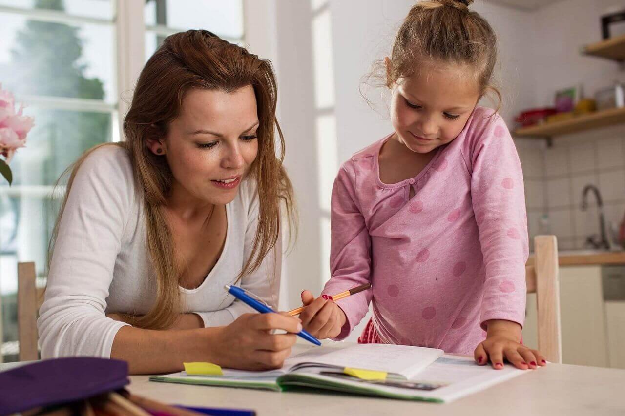 Lady teaching little girl